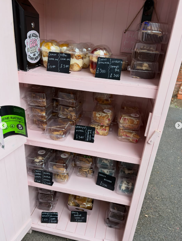 Shelves inside the shed stocked with cake pots and cookies